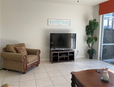 Living area with light tile patterned floors and baseboards