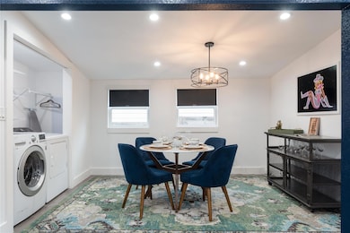 Dining area featuring washing machine and clothes dryer, a chandelier, and recessed lighting