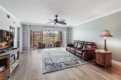 Living room featuring a textured ceiling, built in