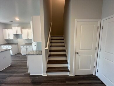 Stairs featuring wood finished floors, visible vents, and baseboards
