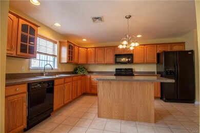 Kitchen with center island and tile floor