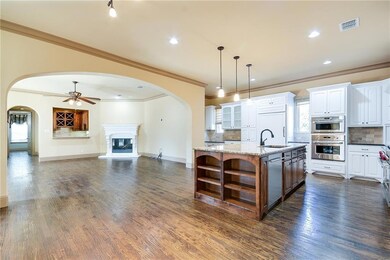 The kitchen and breakfast area are open to the fam