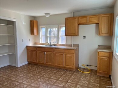 Kitchen featuring light countertops and a sink