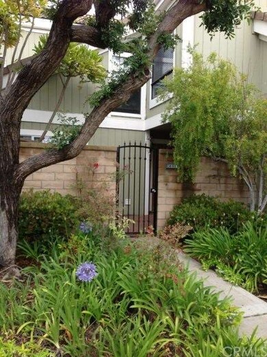 Landscaping leads you to the front gate and patio.