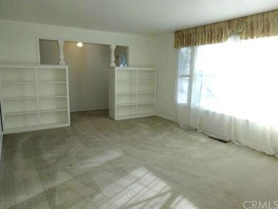 Front formal living room with built-in display she
