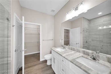 Bathroom with hardwood / wood-style flooring, vani