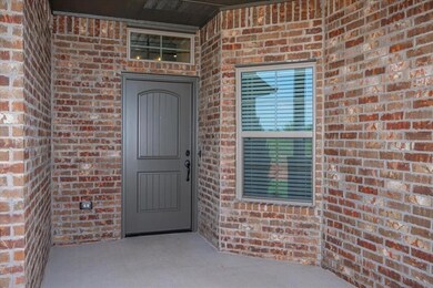 Property entrance featuring brick siding