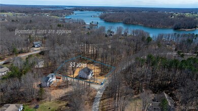 Bird's eye view with a water view and a view of tr