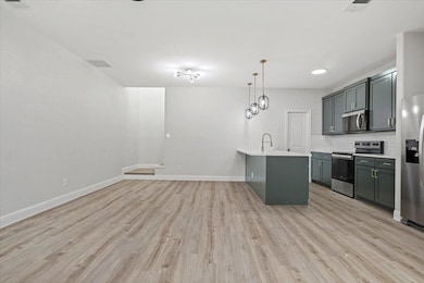 Kitchen featuring decorative backsplash, appliance