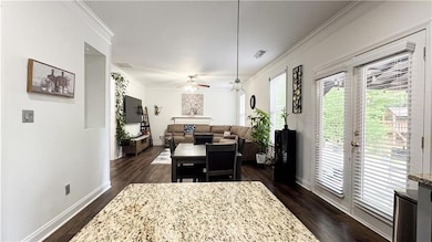 Dining area featuring dark wood-type flooring, bas