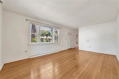 Spare room featuring baseboard heating and light h