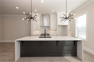 The chef's kitchen boasts quartz waterfall countertops, custom cabinetry and premium appliances. Flowing seamlessly into the dining and living room - perfect for entertaining.