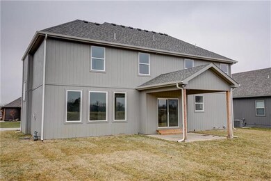 Back of the home.  Cover patio located off kitchen