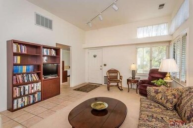 Living room with high ceiling and plantation shutt