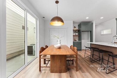Dining area featuring light wood-style flooring and recessed lighting