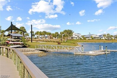 Dock area featuring a water view, a residential view, and a yard