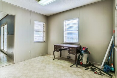Miscellaneous room with wood walls and a textured 