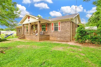 View of front of house with brick siding and roof with shingles
