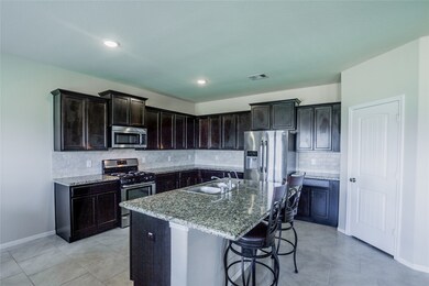 This kitchen is by far any chef’s dream! This spacious kitchen features dark stained wood cabinets, granite countertops, SS appliances, custom tile backsplash, recessed lighting, extended counter space, granite kitchen island with double sink and space for breakfast bar, and a walk-in pantry all overlooking your huge family room.