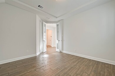 Private study with tray ceiling and double glass privacy door