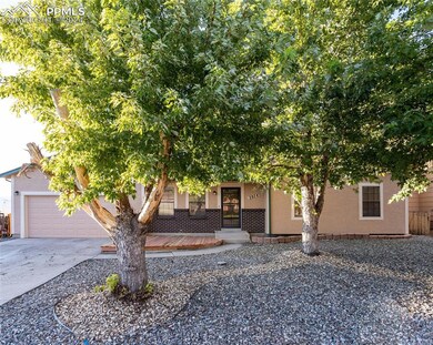 View of front property with trees & garage