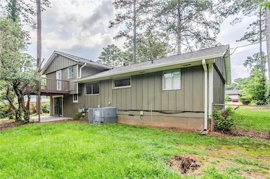 Rear view of house featuring a patio area, board and batten siding, and crawl space