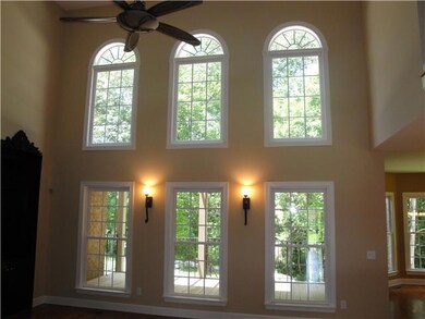 Beautiful windows and soaring ceilings in this great living room.
