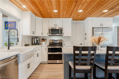 Kitchen with light hardwood / wood-style floors, t