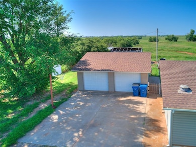 View of front of property with a garage and a shingled roof