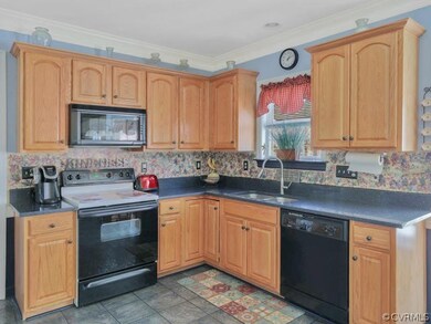 Kitchen has granite counters, ample cabinets and c