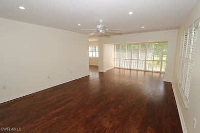 Unfurnished room featuring dark wood-type flooring and ceiling fan