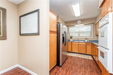 Galley kitchen with large pantry cabinet and lamin
