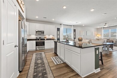 Kitchen featuring stainless steel appliances, a si