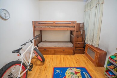 Bedroom with hardwood / wood-style flooring