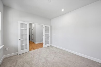 Unfurnished bedroom featuring french doors, carpet, and recessed lighting