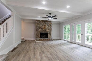 Unfurnished living room with stairway, visible ven