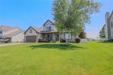 View of front of property with a garage, a front yard, and a porch