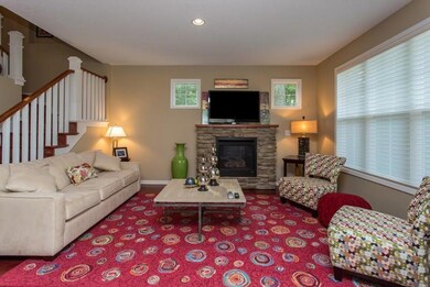 Beautiful living room with custom blinds and a sto