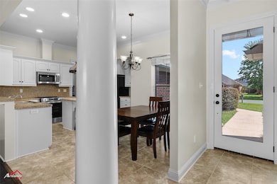 Dining space featuring recessed lighting, ornamental molding, a chandelier, and light tile patterned flooring