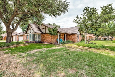 View of front of home with a front yard and a gara