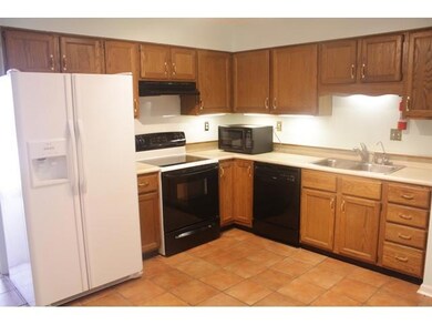 The kitchen is large and the refrigerator, stove, 