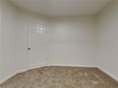 Unfurnished room with carpet flooring and baseboards