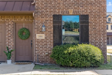 View of exterior entry featuring brick siding