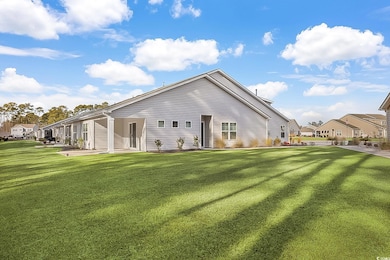 Back of house featuring a lawn