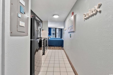 Hallway with electric panel, a textured ceiling, a