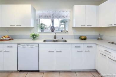 KITCHEN WITH WINDOW FACING SOUTH TO POOL AND LAKE