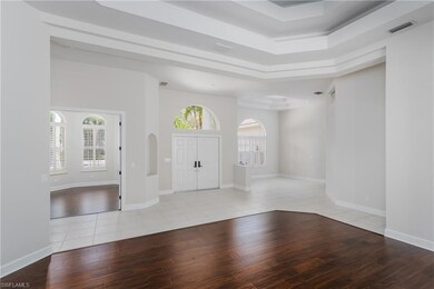 Entryway with a towering ceiling, a raised ceiling