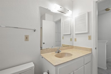 Half bathroom with vanity and toilet
