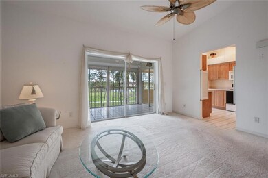 Carpeted living room featuring ceiling fan and vau