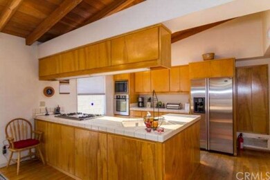 Large kitchen with oak cabinetry and stainless ste